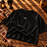Black boxy tee laid flat with a small Chimney Cake crest on the chest
