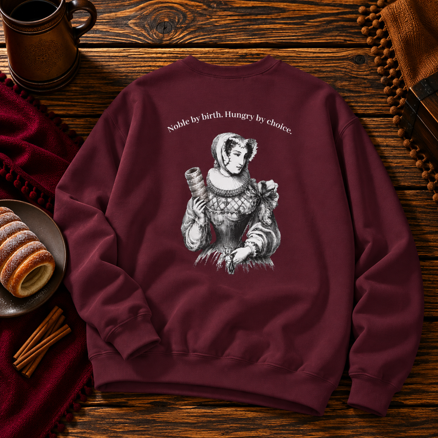 Back of the maroon sweatshirt with the Renaissance lady and her chimney cake under Noble by birth. Hungry by choice.