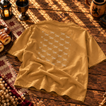 Back of the mustard gold tee covered in a repeating pattern of dachshund chimney cakes