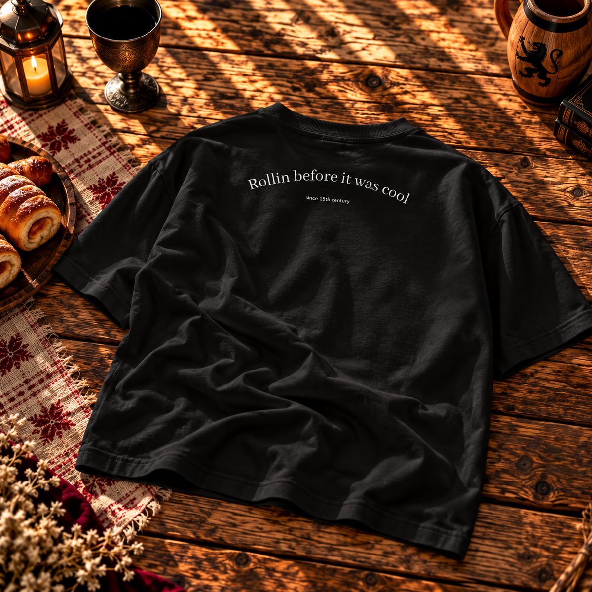 Back of the black boxy tee printed Rollin before it was cool, since 15th century in white