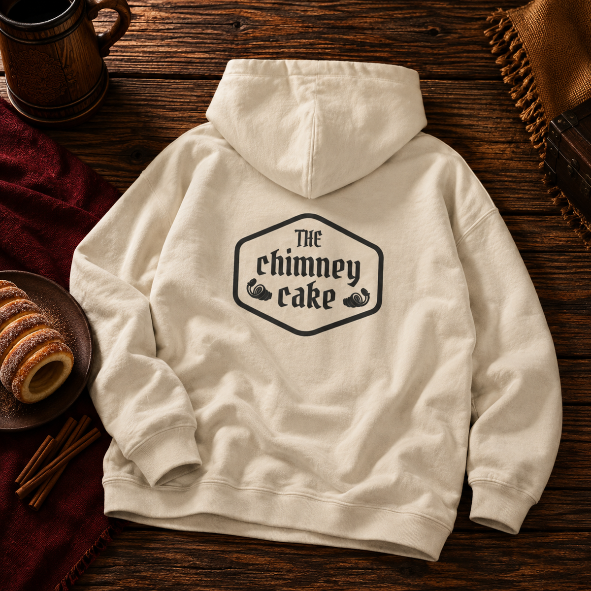 Back of the Sand hoodie with a large Chimney Cake crest