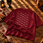 Back of the cardinal red kids’ tee covered in a repeating pattern of dachshund chimney cakes